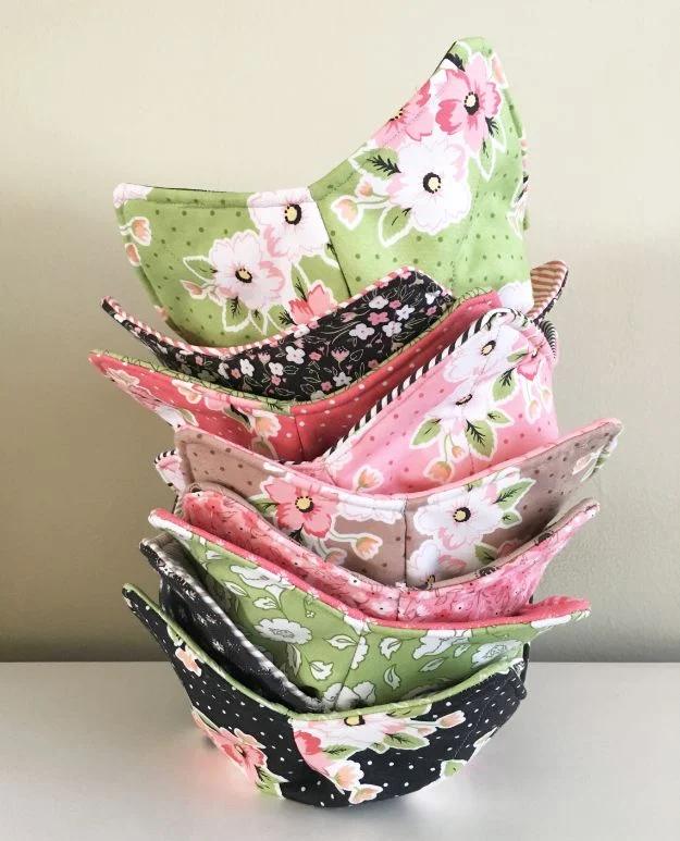 A cotton soup bowl cozy cradling a hot bowl on a kitchen table, quilted from cotton batting and fabric scraps