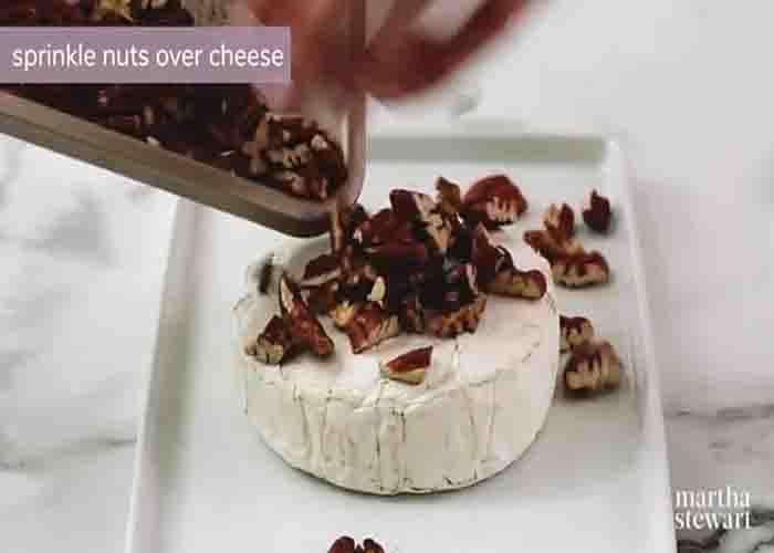 Adding the pecans over the brie cheese