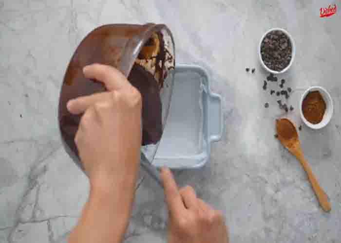 Transferring the brownie batter into the prepared container