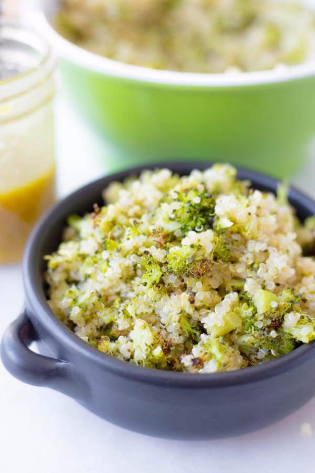 Roasted broccoli and quinoa salad tossed in honey mustard dressing in a large serving bowl for a filling plant based dinner
