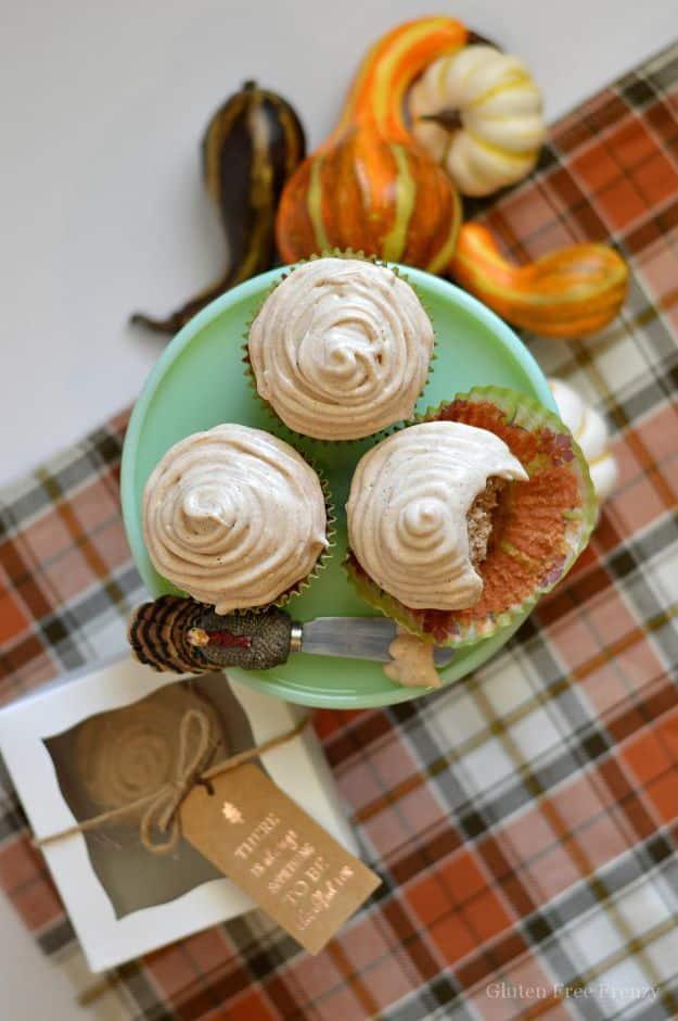 Gluten free apple cider cupcakes topped with swirled cinnamon cream cheese frosting and a cinnamon dusting