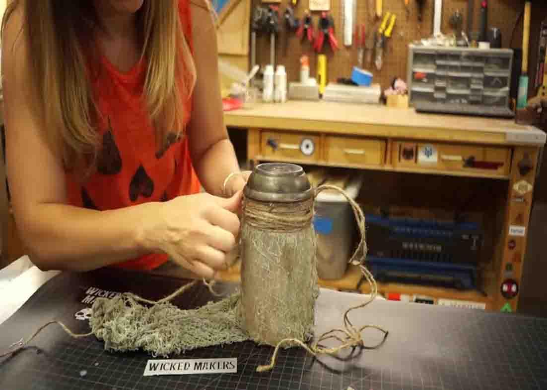 Attaching the rope to hang the DIY mason jar hanging Halloween light