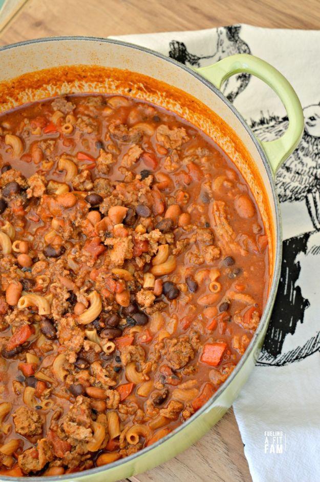 Chili mac simmered in a dutch oven with ground beef, pasta and melted cheese for a hearty one pot dinner