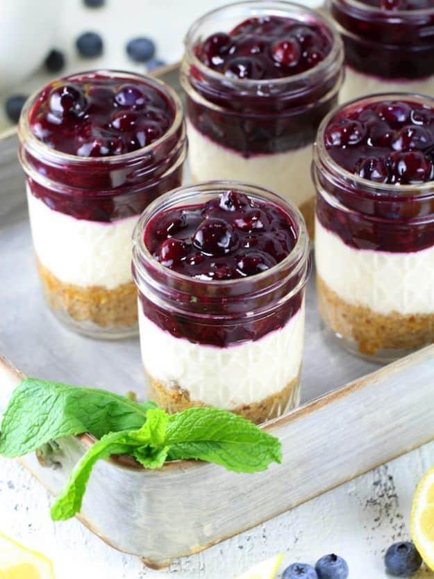 Blueberry lemon no bake cheesecake jars layered with blueberry sauce, lemon filling and graham crust