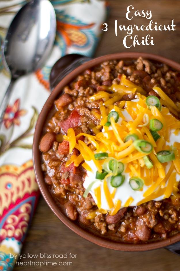 A bowl of easy 3 ingredient chili topped with shredded cheddar and sour cream, a fast weeknight dinner recipe
