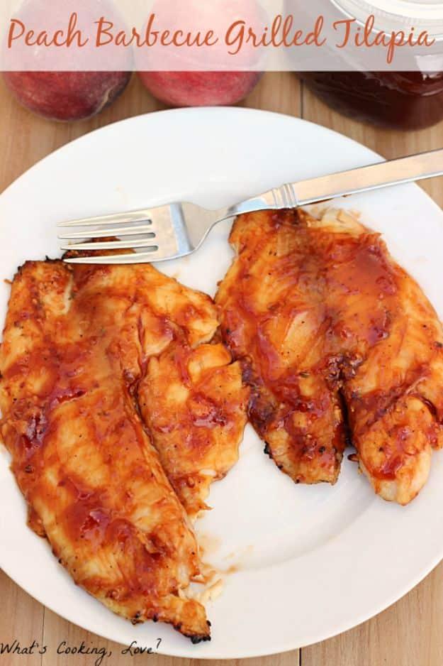 Peach barbecue grilled tilapia with grill marks and fresh peach slices, a sweet and smoky summer fish recipe