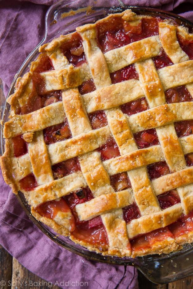 Strawberry rhubarb pie with a lattice crust over a thick jammy pink strawberry and rhubarb fruit filling