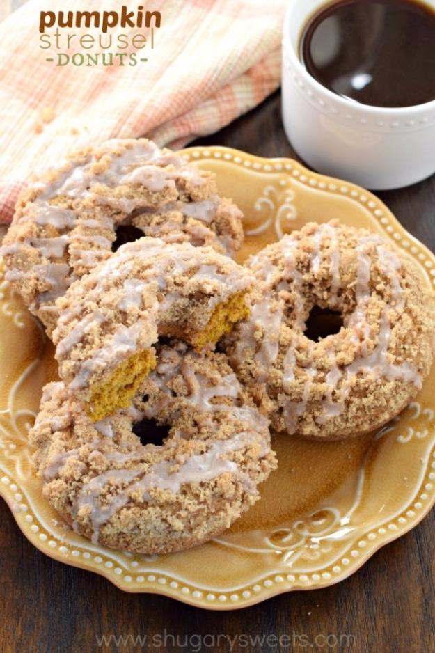 Typeset graphic titled pumpkin streusel donuts, glazed crumb topped donuts on a gold scalloped plate with coffee