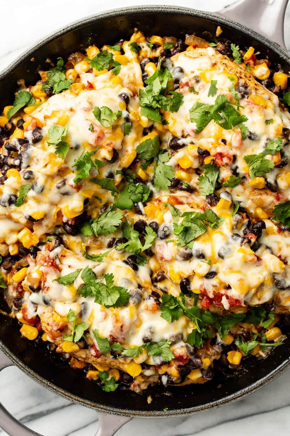 Santa Fe chicken skillet cooked with black beans, corn, and cheese in thirty minutes flat for the whole family