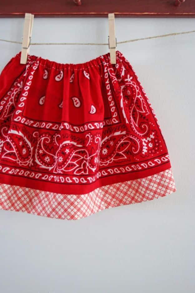 Bandana skirt tutorial for girls, a red skirt with a gingham hem band pegged on twine against a white wall