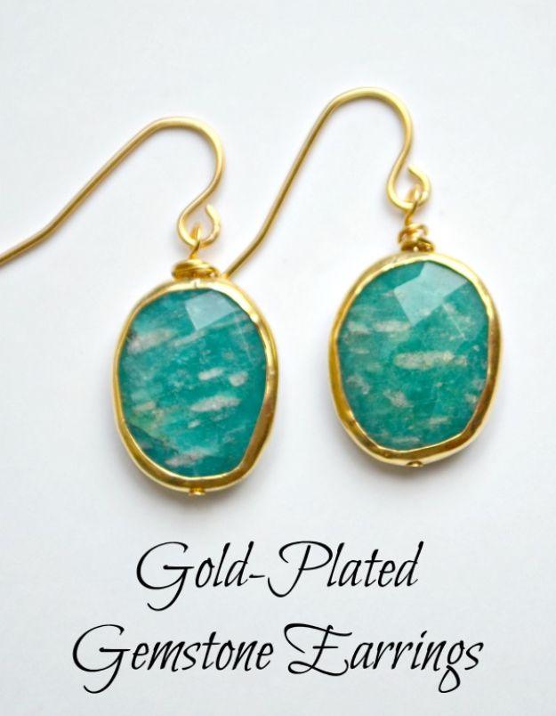 Gold plated gemstone earrings, two teal amazonite stones in gold bezels on gold French ear wires against white