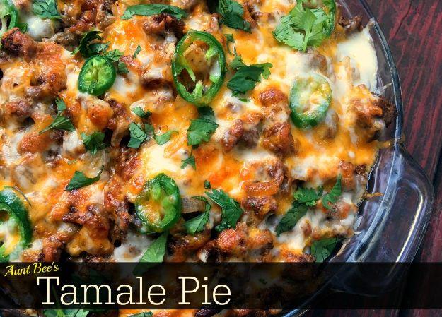 Tamale pie with a Jiffy cornbread base soaked in enchilada sauce under seasoned ground beef and cheese