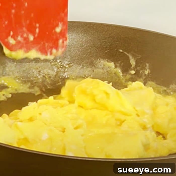 Perfectly Fluffy Scrambled Eggs 3 Cooking scrambled eggs with the push and fold technique for maximum fluffiness. Eggs are gently moved, not stirred.