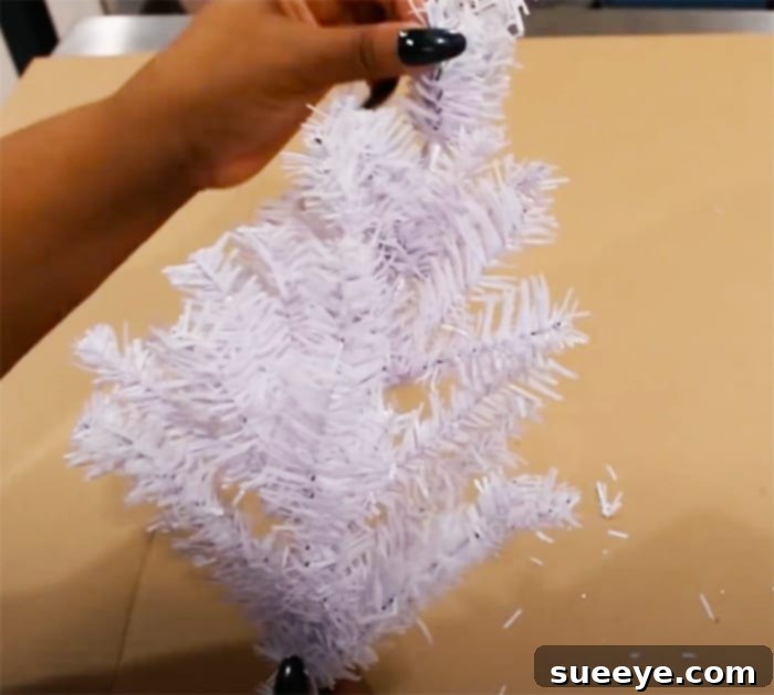 Sparkling Dollar Tree Snowflake Wreath 2 Learn how to make an inexpensive yet luxurious-looking DIY snowflake wreath using mini Christmas trees from Dollar Tree.