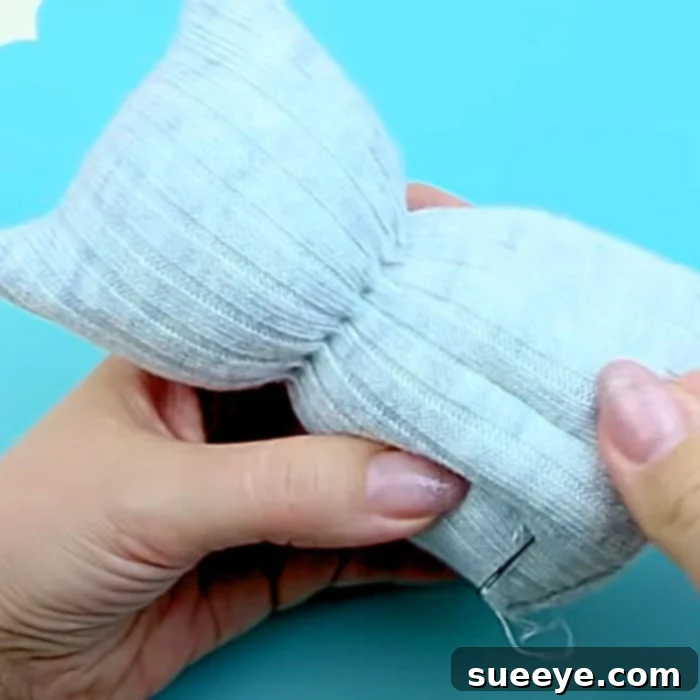 Transform Old Socks Into Cute Kittens 2 Easy Sock Project Ideas - How To make A Sock Puppet - Sock Kitty Idea - Drawing the pattern on an inside-out sock for a DIY cat toy.