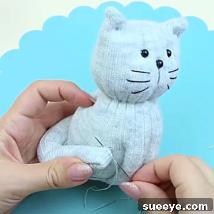 Transform Old Socks Into Cute Kittens 3 DIY Sock Toy - Free Sock To Pattern - Easy Sock Toy Pattern - DIY Cat - Adding button eyes and embroidered features to a handmade sock kitty.