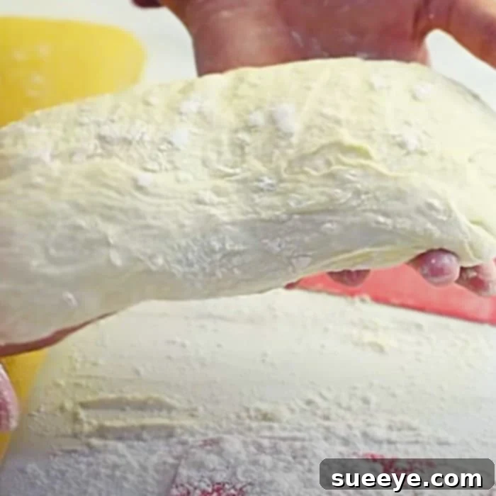 Bakery-Quality Ciabatta, Simplified 2 Preparing ciabatta dough for an easy homemade artisan bread recipe, showcasing the wet, sticky texture before the first proof.