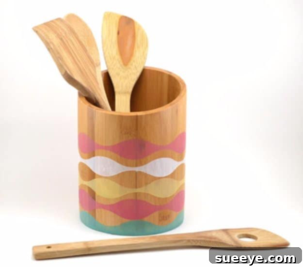 DIY Stained Bamboo Utensil Holder for Kitchen Countertop Stained bamboo utensil holder with decorative striped pattern, holding kitchen tools