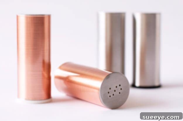 DIY Metallic Salt and Pepper Shakers for Chic Kitchens Modern DIY metallic painted salt and pepper shakers on a kitchen table