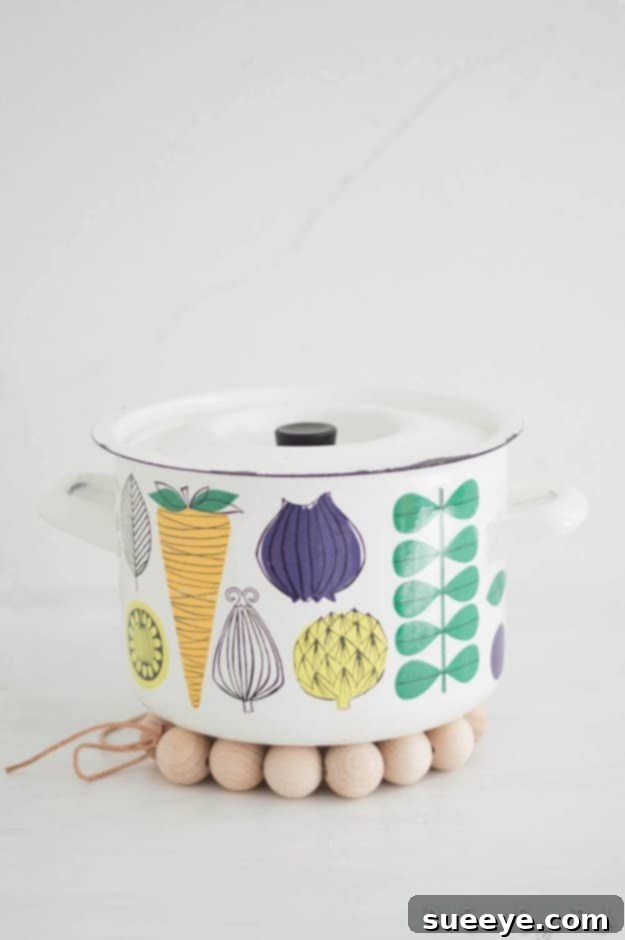 DIY Wooden Bead Trivet for Rustic Kitchen Decor and Protection Handcrafted DIY wooden bead trivet protecting a surface from a hot pot
