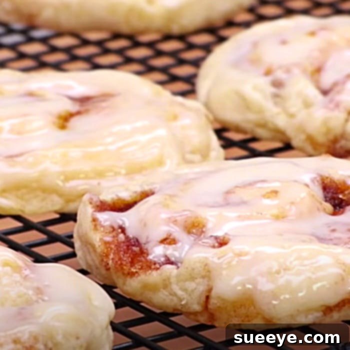 Ultimate Cinnamon Roll Cookies 3 Delicious cinnamon roll cookies generously topped with homemade vanilla icing, fresh from the oven.