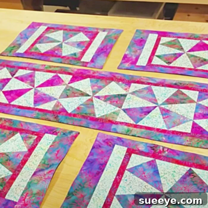 Craft Charming Windmill Placemats: Free Pattern Inside 3 Several patchwork quilt blocks sewn into a larger unit, demonstrating the progress of the quilting project