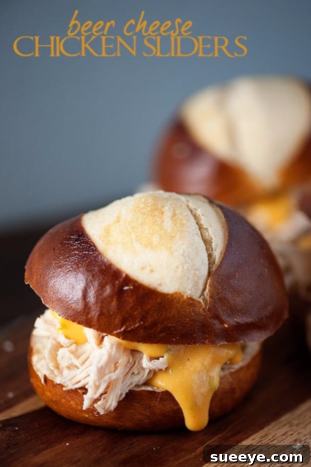 Beer Cheese Chicken Pretzel Sliders - Indulgent 4th of July Bites Best Fourth of July Recipe Ideas - Beer Cheese Chicken Pretzel Sliders