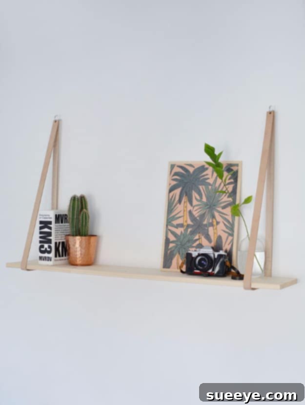 Chic and simple leather strap hanging shelf for a bohemian or minimalist look