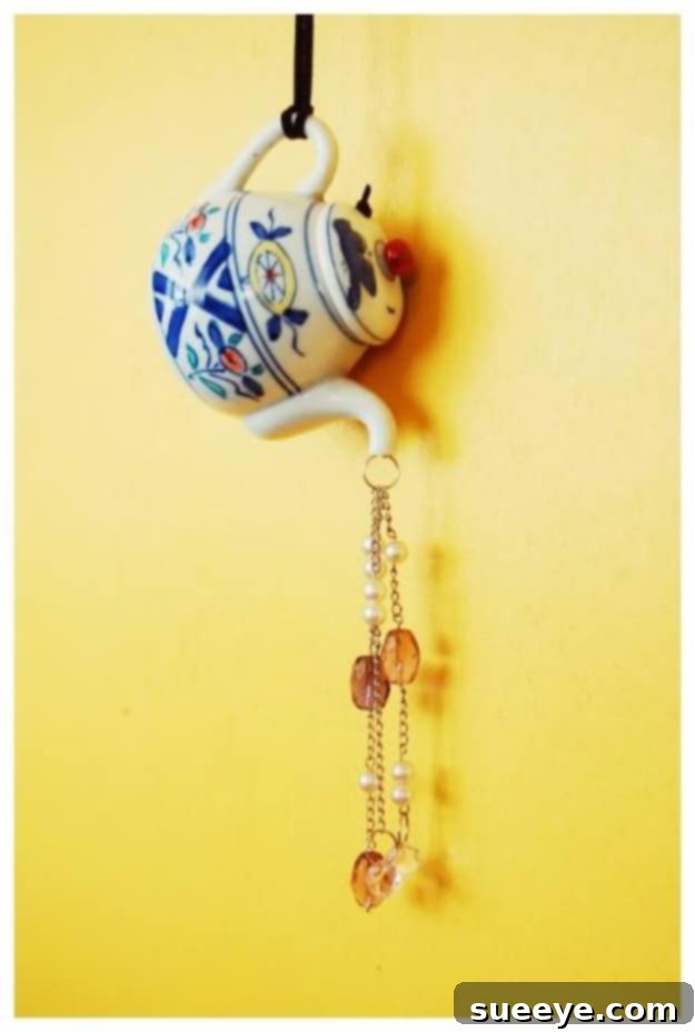 DIY Teapot Suncatcher Wind Chimes - Quaint Garden Art DIY Teapot Suncatcher Wind Chimes - Repurposed Teapot with Hanging Charms and Beads