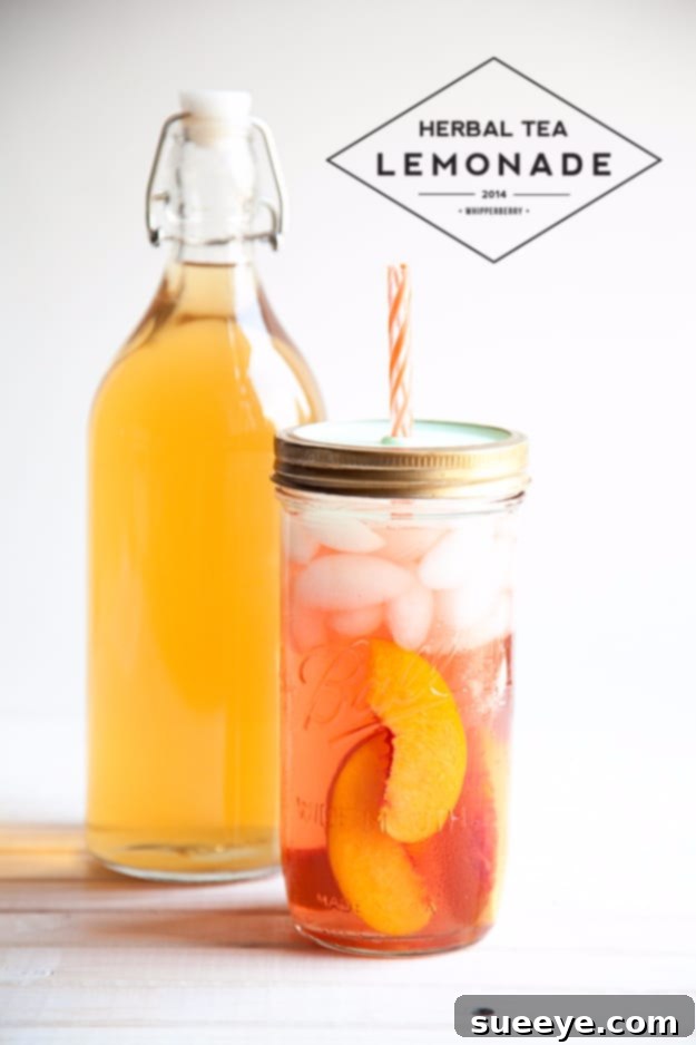Refreshing Herbal Tea Lemonade: A Soothing Summer Blend Herbal Tea Lemonade served in a tall glass jar, garnished with a lemon wedge.