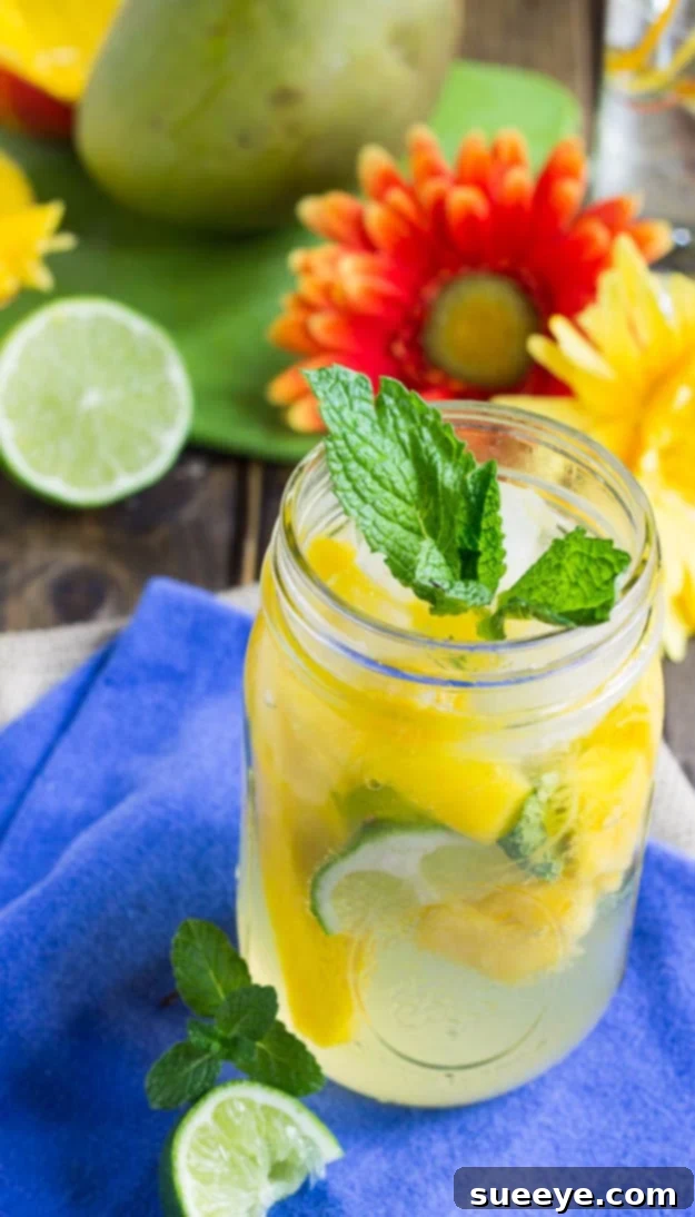 Exotic Mango Mojito: A Tropical Summer Cocktail Tropical Mango Mojito in a glass, garnished with fresh mint and mango slices.