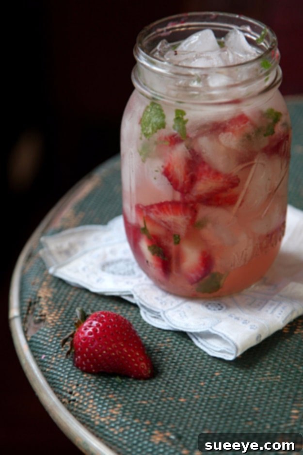 Modern Strawberry Moonshine Julep: A Spirited Southern Twist Strawberry Moonshine Julep in a classic julep cup, garnished with fresh strawberries and mint.