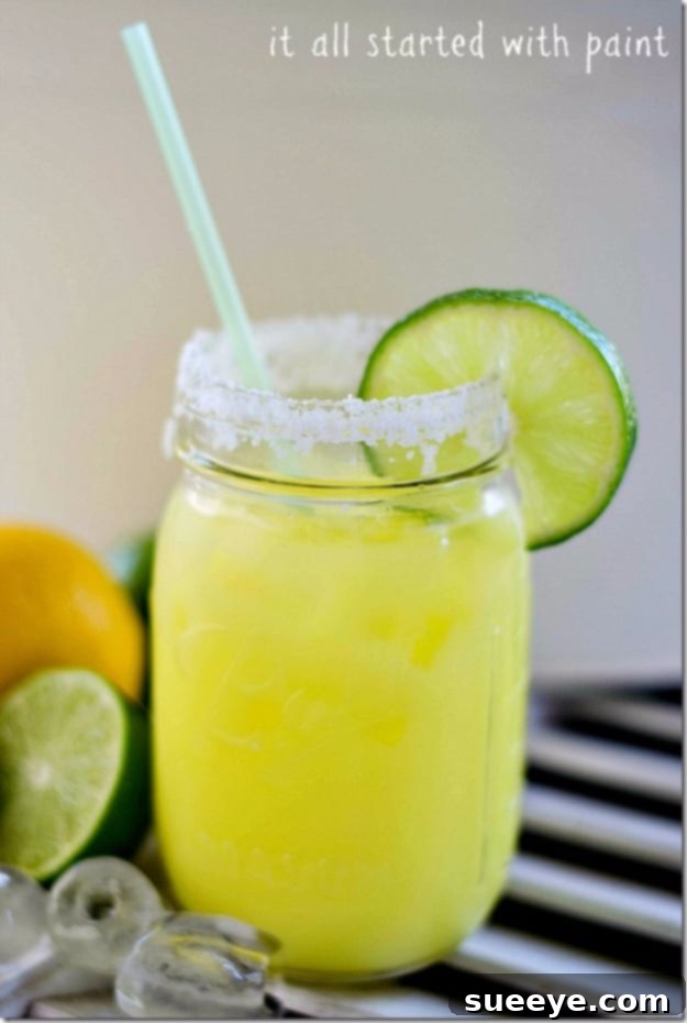 Guilt-Free Low Cal Margarita in a Jar: Light Summer Cocktail Low Cal Margarita in a mason jar with lime slices and a salted rim.