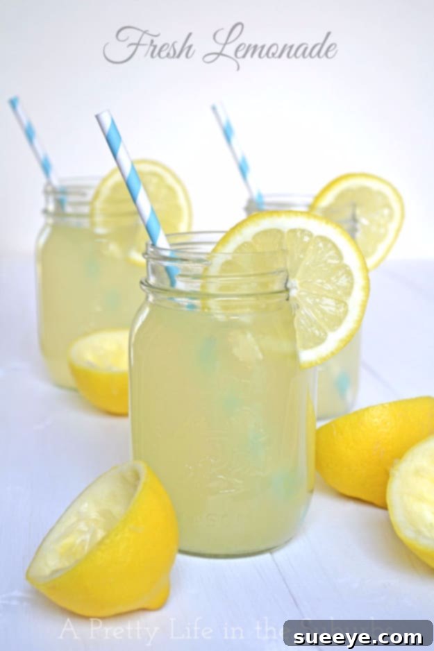 Classic Fresh Real Lemonade: Timeless Summer Refreshment Classic Fresh Real Lemonade served in a mason jar with a striped straw and lemon slices.