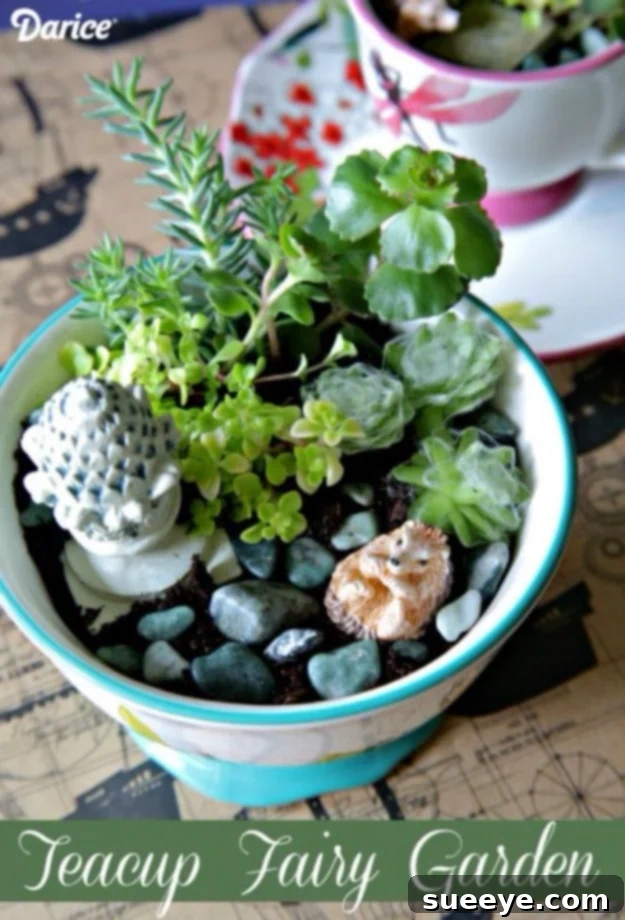 DIY teacup mini garden with small plants and decorative elements