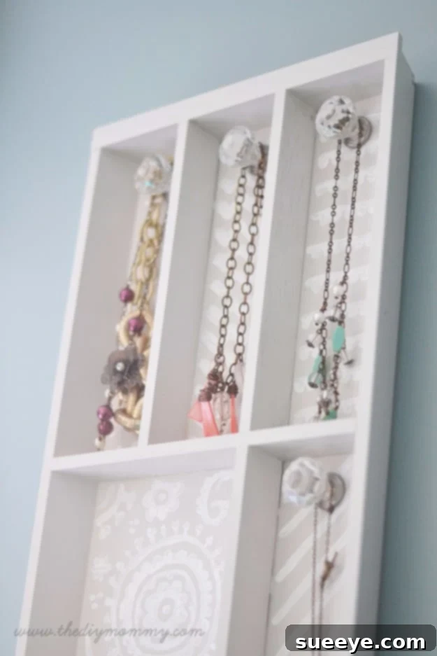 DIY jewelry holder made from a repurposed cutlery tray for organization