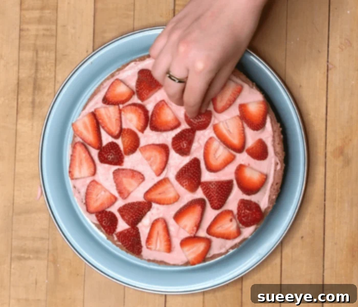 Ultimate Strawberry Cake Recipe 9 Decorating Strawberry Cake Layers with Cream Cheese Frosting and Fresh Berries