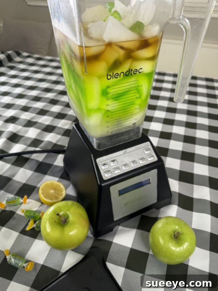 Rancher's Crown Royal Apple Slush 11 All ingredients, including ice, inside the blender, ready for blending