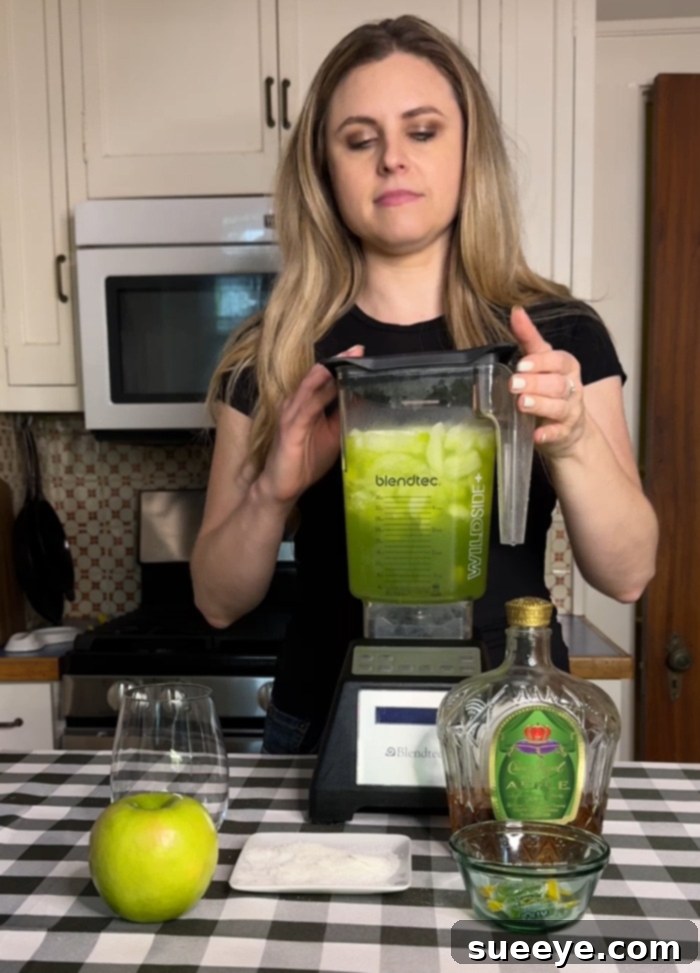 Rancher's Crown Royal Apple Slush 12 Blender actively mixing the Crown Royal Apple slushie ingredients