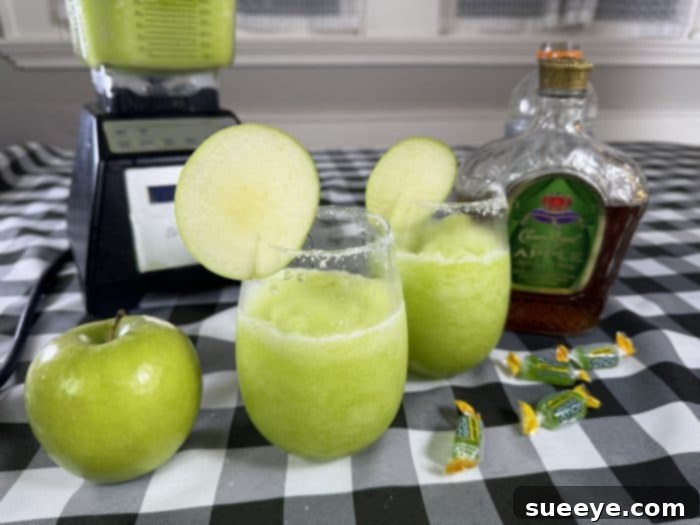 Rancher's Crown Royal Apple Slush 16 Multiple glasses of Crown Royal Apple slushies served on a tray with snacks at a summer gathering