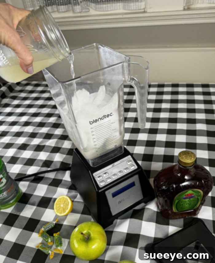 Rancher's Crown Royal Apple Slush 5 Pouring lemonade into a blender carafe