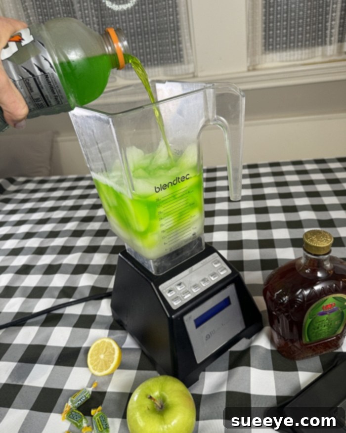 Rancher's Crown Royal Apple Slush 6 Adding green apple Gatorade to a blender with lemonade