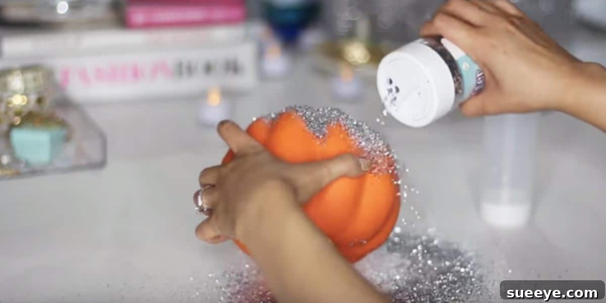 Glitter-covered pumpkin transformed into a charming votive candle holder