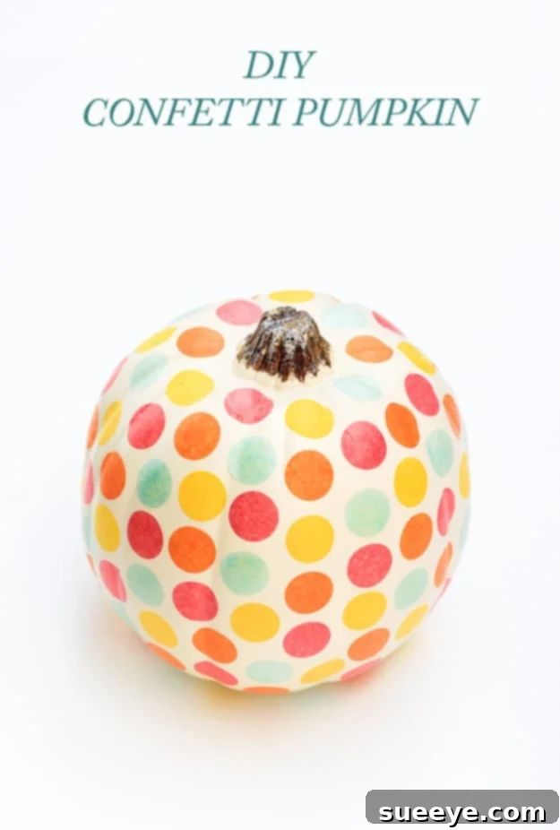 White pumpkin decorated with a playful scattering of colorful confetti