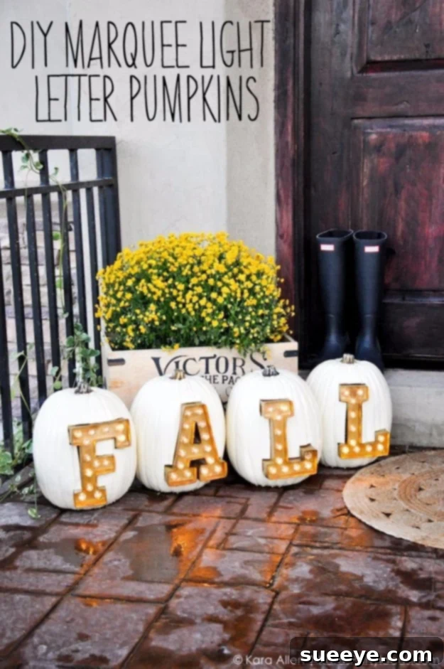 Pumpkins carved with letters and illuminated with marquee lights