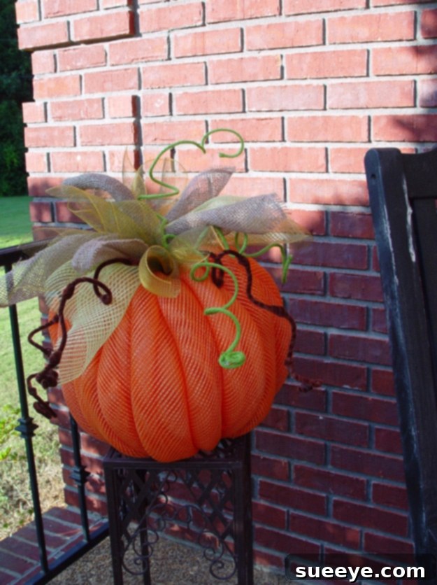 Pumpkin crafted from colorful deco mesh for a vibrant and textured fall decoration