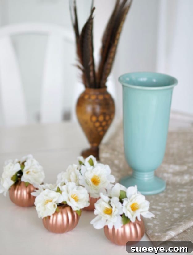 Shimmering copper-painted pumpkins arranged as a stylish fall centerpiece