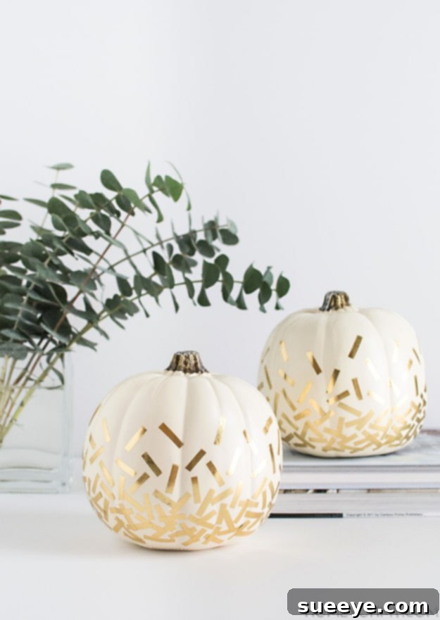 White pumpkin decorated with festive gold confetti for a modern fall look