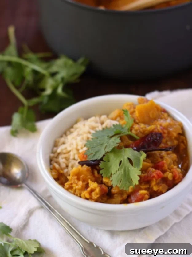 Red Lentil Pumpkin Dal - Vegan Fall Recipe Hearty Red Lentil Pumpkin Dal, a comforting and nutritious vegan Indian-inspired dish perfect for fall.