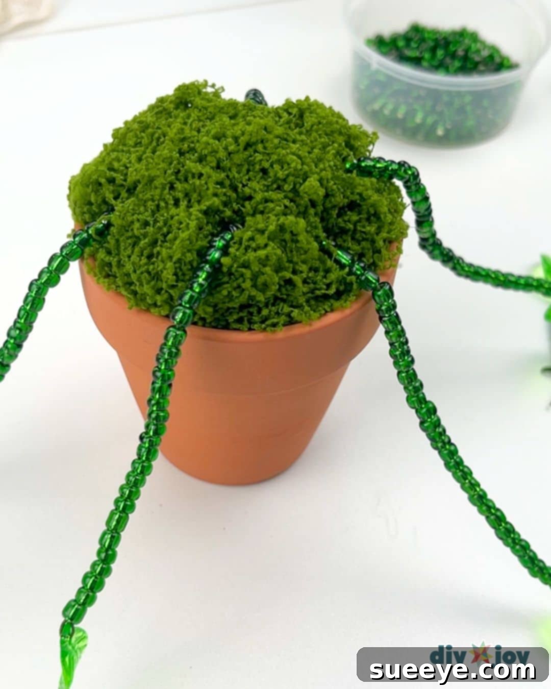 Crafting Exquisite Beaded Plants 8 Inserting long beaded stems into the styrofoam for a cascading plant effect